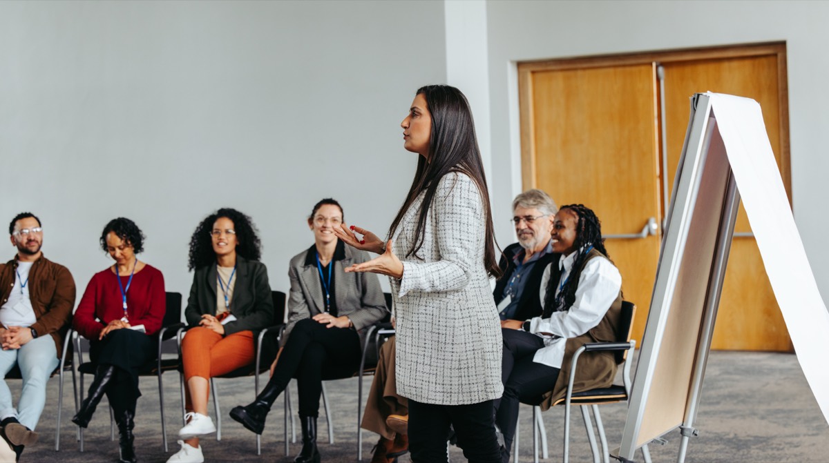 A facilitator leads an interactive workshop with a diverse group of employees